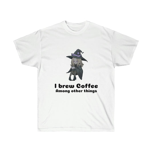 A white coloured t-shirt with a blond witch in a black robe and hat drinking coffee. The black text reads "I brew coffee among other things"