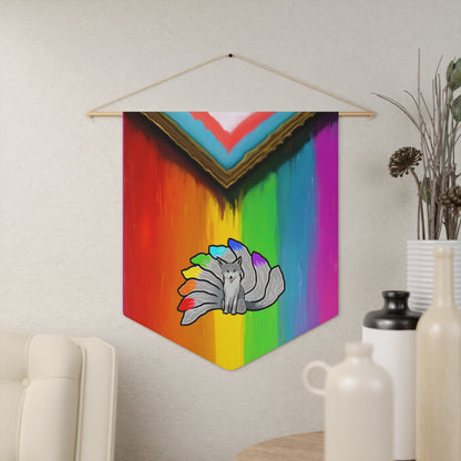 A pennant with a grey nine tailed kitsune in the middle of a rainbow in the colors of the LGBTQ+ flag.