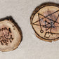 Two wooden sigils. One is the sigil for Belial. The other is So a sigil of the covenant of the elder gods, a symbol of GANZAR, and the sigil of the watcher, combined into a talisman.