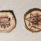 Two wooden sigils. One is the sigil for Belial. The other is So a sigil of the covenant of the elder gods, a symbol of GANZAR, and the sigil of the watcher, combined into a talisman.