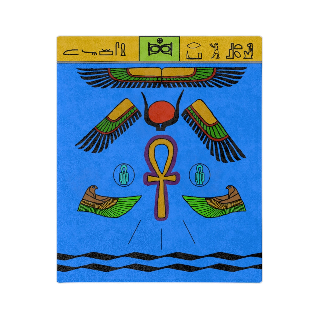 A blue blanket with various symbols dedicated the goddess Isis. The main ones are hieroglyphics at the top on a yellow and green border, multi-coloured wings, a golden ankh outlined in purple, and birds with their wings pointed towards the ankh.