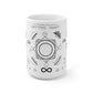 A white mug sitting on a white background. On the top of the mug is the text "Transmute Coffee" in latin. There are an assortment of symbols around the mug. The main one in the center is a composite custom designed for enchanting. It shows the four alchemical suns and transition states of process. It represents the process of alchemy itself. Below it is the infinity symbol. Along either side of the infinity symbol are the zodiac signs. 