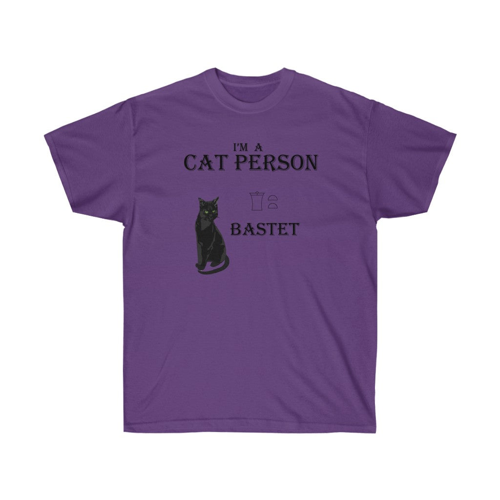 A purple shirt. It has black house cat in the middle. At the top, there is text that reads "I'm a cat person." Below the text is a black cat. Beside the cat are a few hieroglyphs and below that, the name "Bastet".