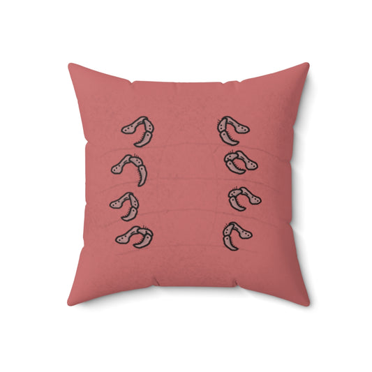 A dark pink throw pillow. It prominently features 8 legs that look like hermit crab legs (Segmented with hairs on them, curving at each segment), 4 on each side.