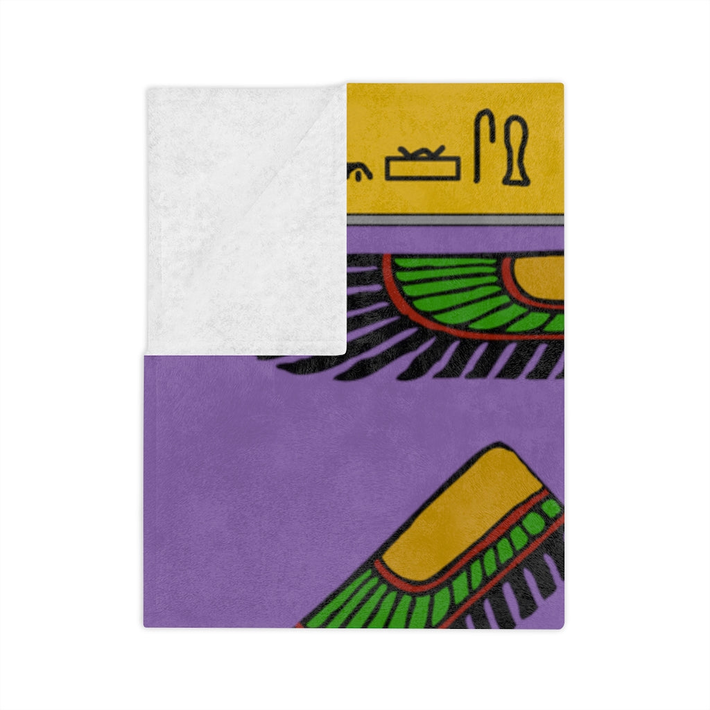 A purple blanket dedicated to the goddess Isis. The corner of the blanket has been folded, partially obscuring the hieroglyphics at the top.