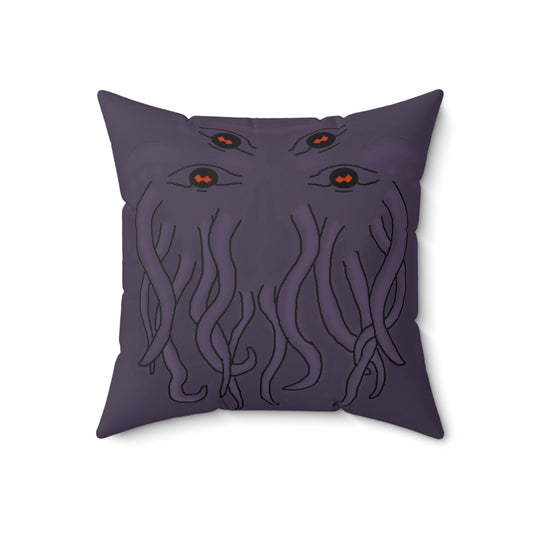 A purple throw pillow with a stylized rendition of cthulu's face on it. It prominently features four eyes at the top and his tentacles below them.