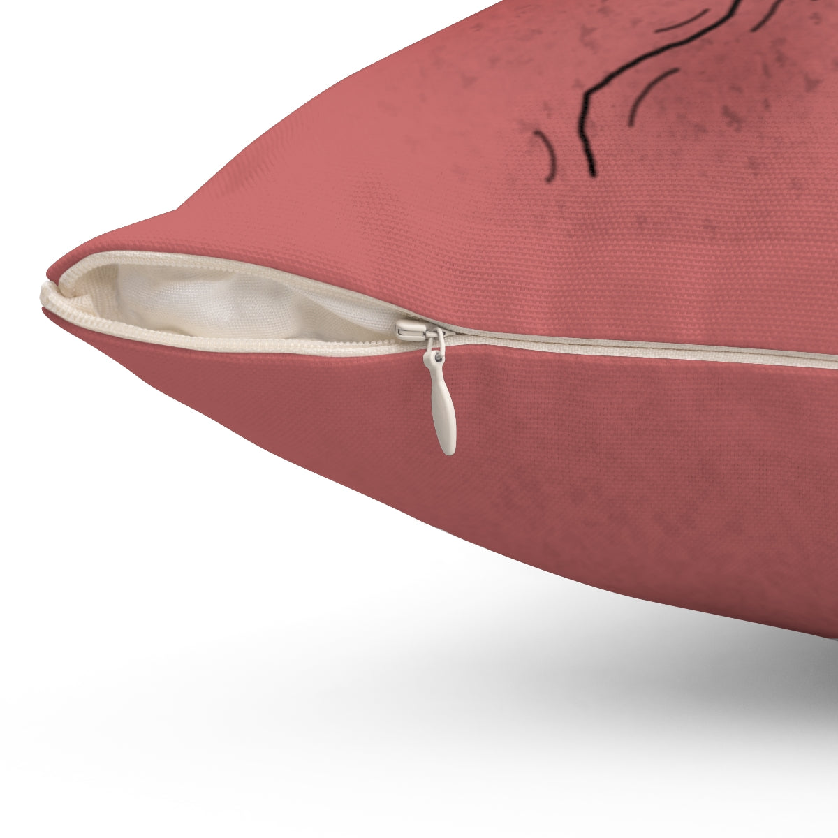 A dark pink throw pillow. The zipper that removes the cover is zoomed in on. 