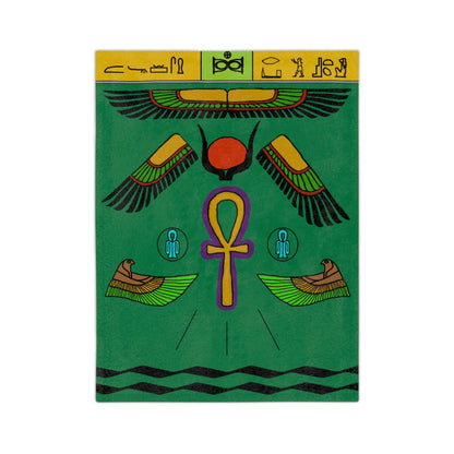 A green blanket with various symbols dedicated the goddess Isis. The main ones are hieroglyphics at the top on a yellow and green border, multi-coloured wings, a golden ankh outlined in purple, and birds with their wings pointed towards the ankh.